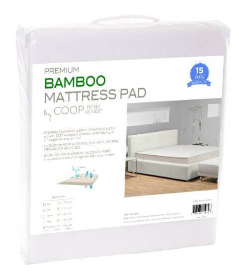 Packaging for a Premium Coop Mattress Pad by Coop Home Goods. The package features an image of a bed with the mattress pad in a modern bedroom setting. Key features and benefits are listed, along with a 15-year warranty seal on the top right corner.