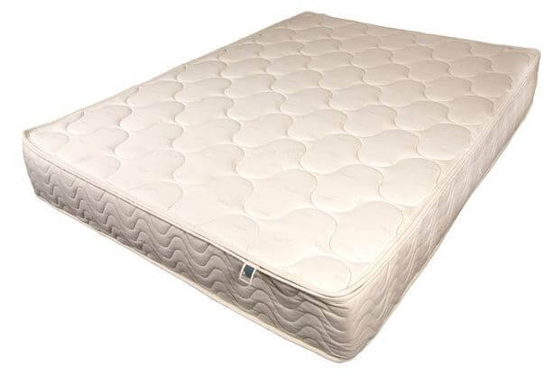 A photo showing a white spindle mattress with a quilted pattern on the surface. The mattress has a thick, rectangular shape and appears to be clean and in good condition. A small fabric tag is visible along the bottom edge.