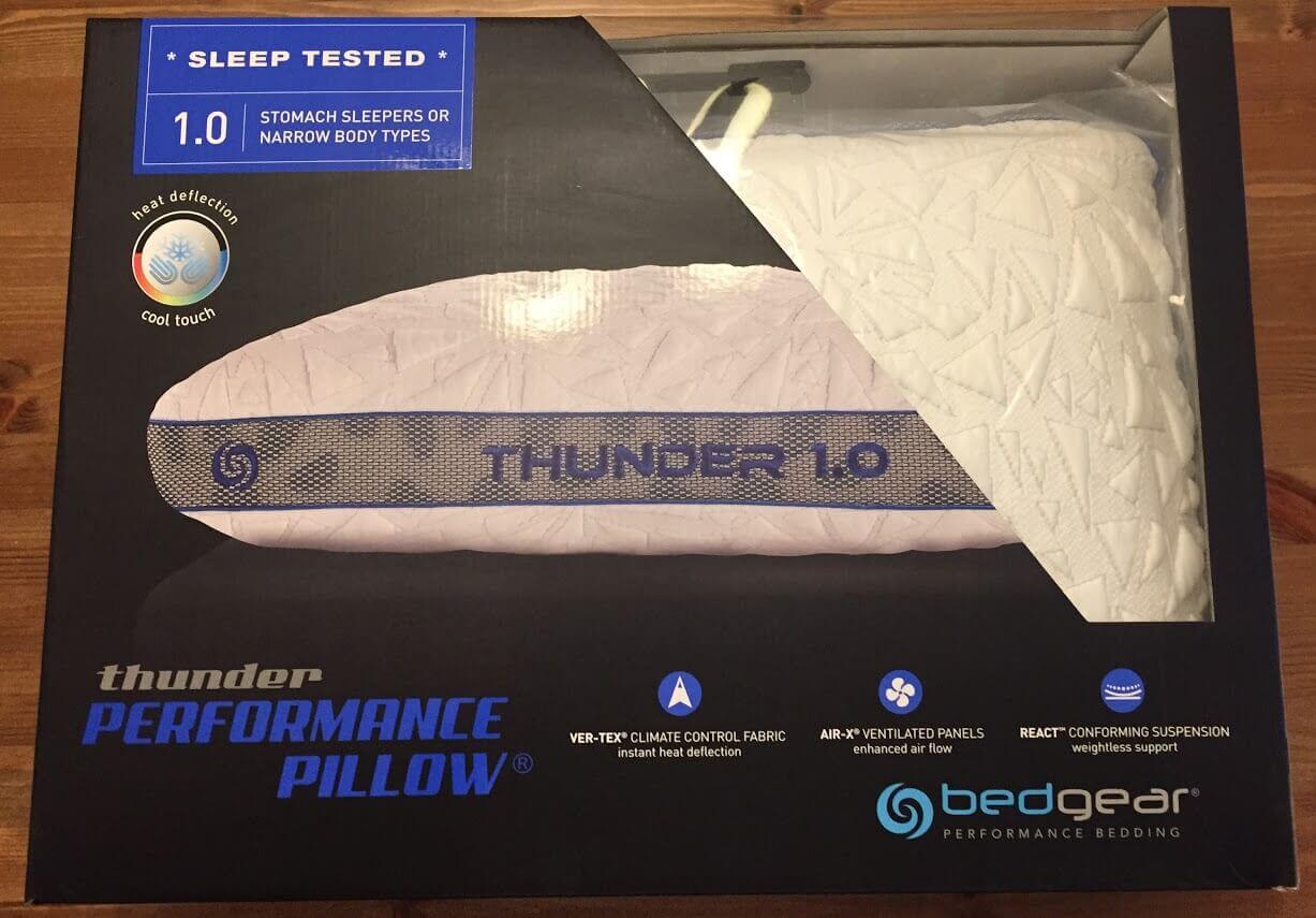 A Bedgear "Thunder Performance Pillow 1.0" in its packaging proudly showcases features like "sleep tested," "heat deflection cool touch," and is ideal for stomach sleepers or narrow body types. It also boasts Ver-Tex climate control fabric, Air-X ventilated panels, and a React conforming suspension.