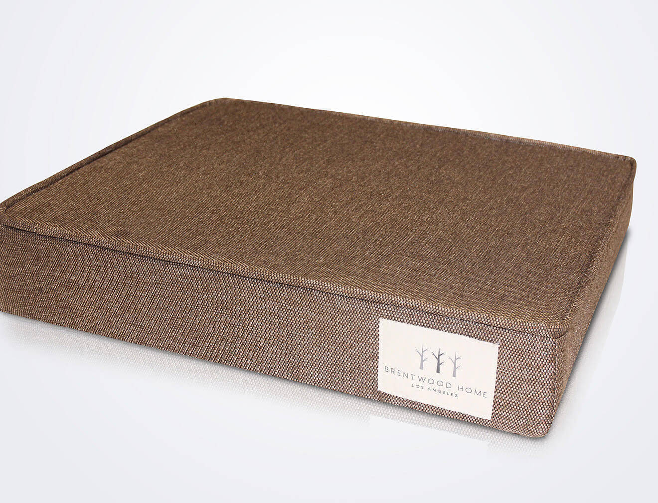 A rectangular, brown Brentwood Home dog bed with a firm cushion and textured fabric. The bed features a white tag that reads "Brentwood Home" in the bottom corner. The background is plain white.