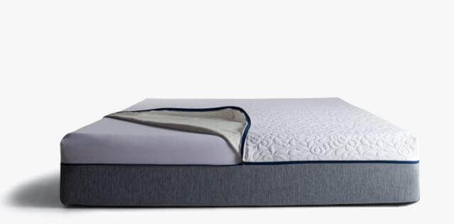 A modern, gray and white Novosbed mattress with a section of the top cover folded back, revealing the layers underneath. The top layer features a textured, floral-like design. The background is plain white, emphasizing the mattress.