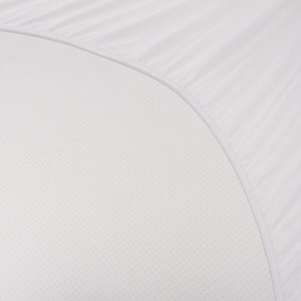 Close-up view of Solis Blue Ice™ fabric, showcasing its smooth texture and fine circular patterns. The white material is neatly stretched with a subtle curve, suggesting it may be part of a fitted sheet or mattress cover.