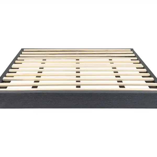 The Low Profile Ready To Assemble Foundation is a modern, minimalist platform bed frame featuring a grey fabric-wrapped base and evenly spaced wooden slats designed to support a mattress without requiring a box spring.