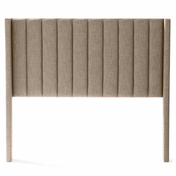 The Blackwell Headboard features a beige, upholstered design with vertical tufting. This headboard is flat and extends down to the floor, supported by slim, straight legs on either side. The fabric texture is soft and smooth against a white background.