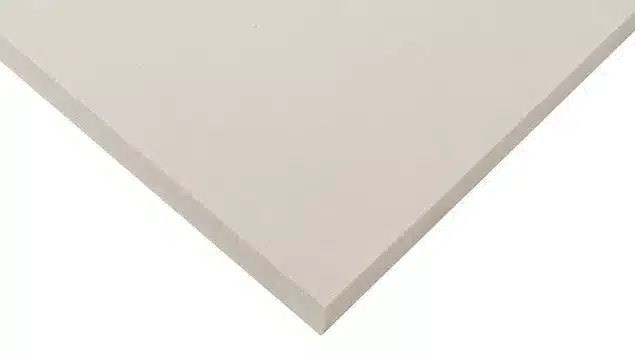 A close-up view of a corner of the Bear Pro Mattress Topper, showcasing its flat, beige rectangular design with sharp edges and smooth surfaces. Positioned against a white background, the topper is slightly elevated to highlight its thickness and clean, minimalist style.