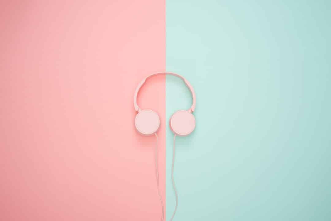a pink headphones on a pink and blue background