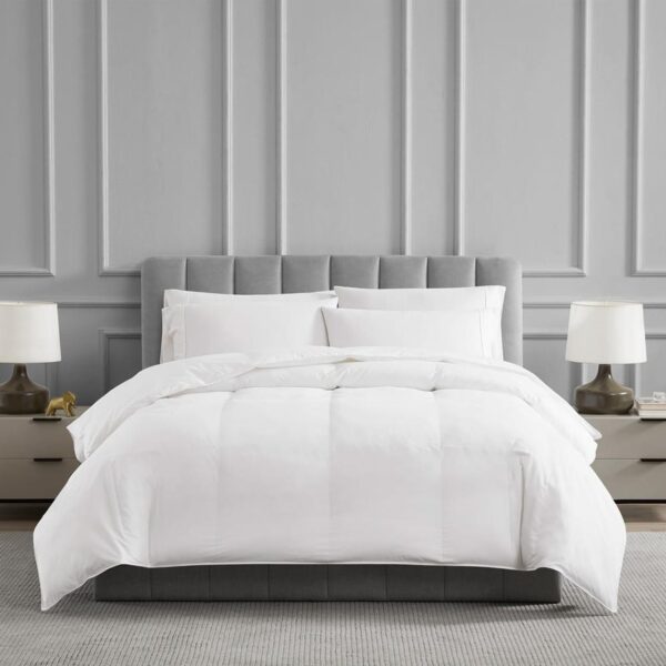 Cozy bed with white comforter.