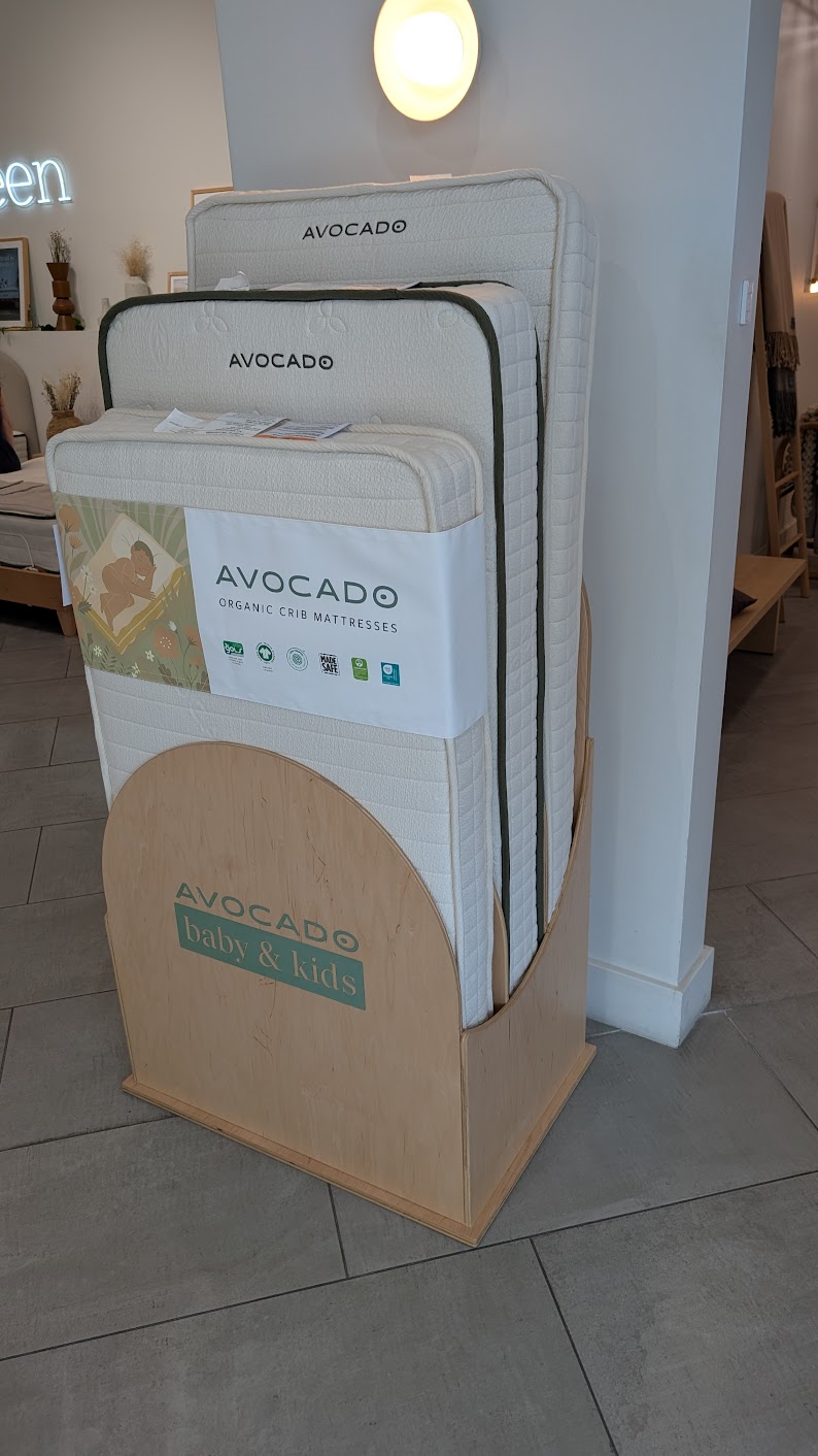Avocado organic crib mattresses on display at the Yawnder San Diego showroom