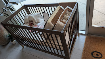 Avocado organic crib mattress inside a crib at the Yawnder showroom