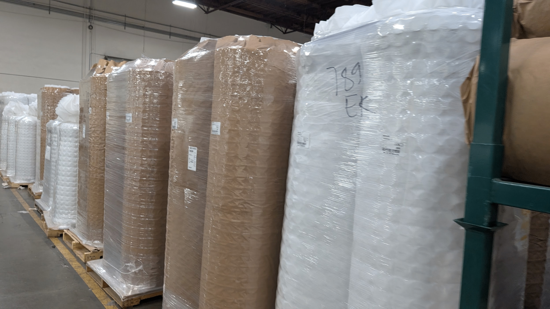 Pocketed coil units and organic latex stacked on pallets at the Avocado factory