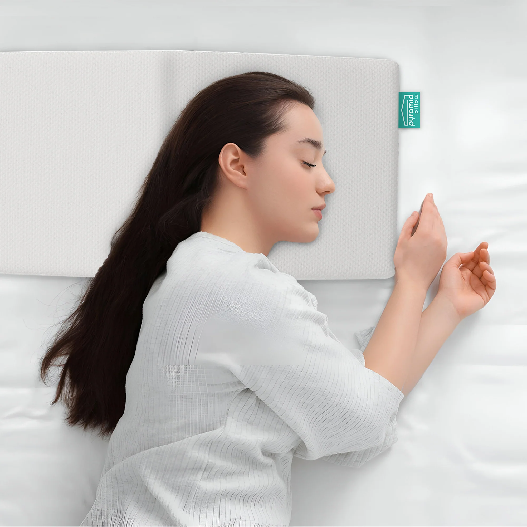 Woman side sleeping on the Pyramid Pillow anti-snore memory foam pillow