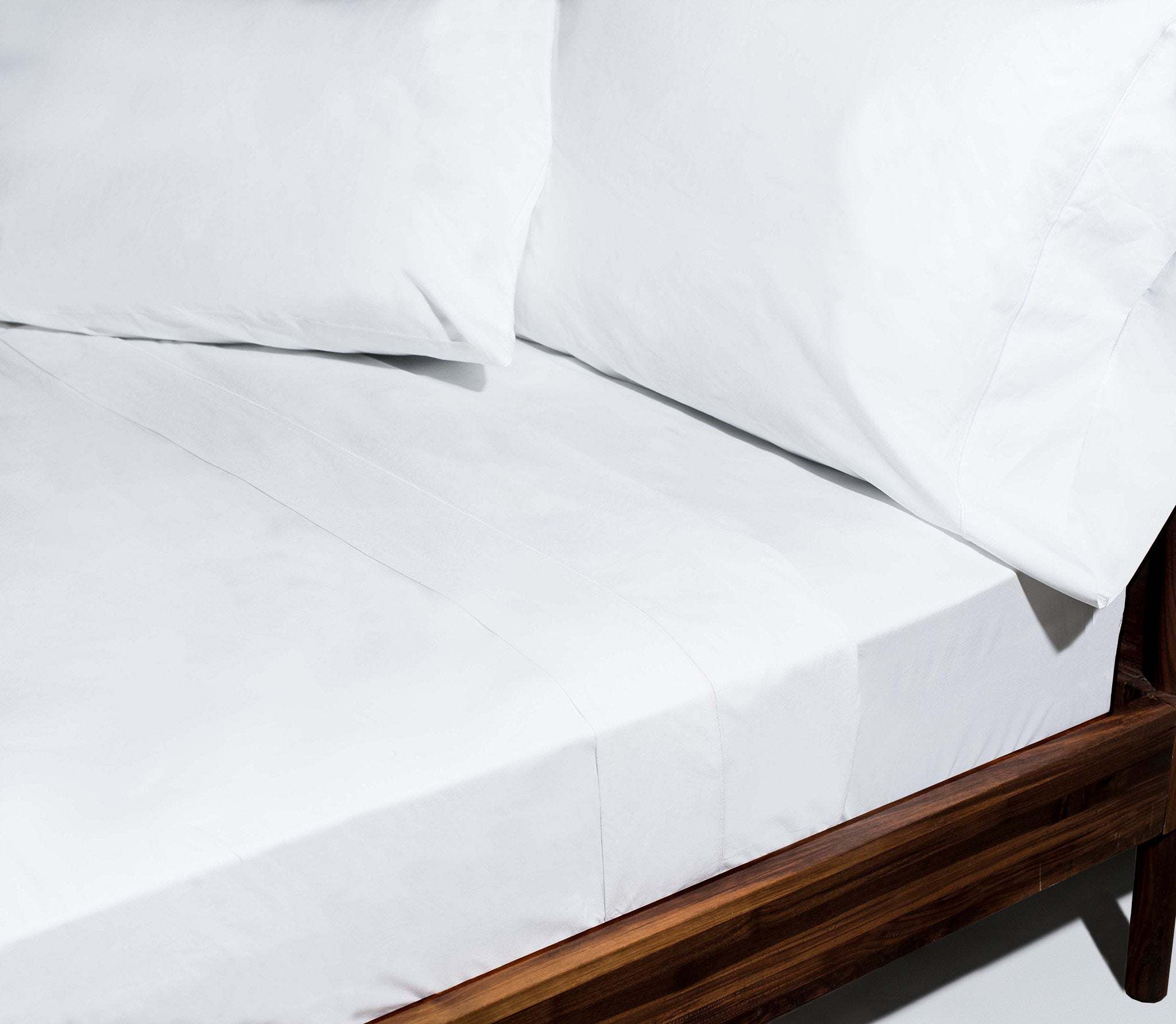 Snowe Percale Sheet Set styled on a bed