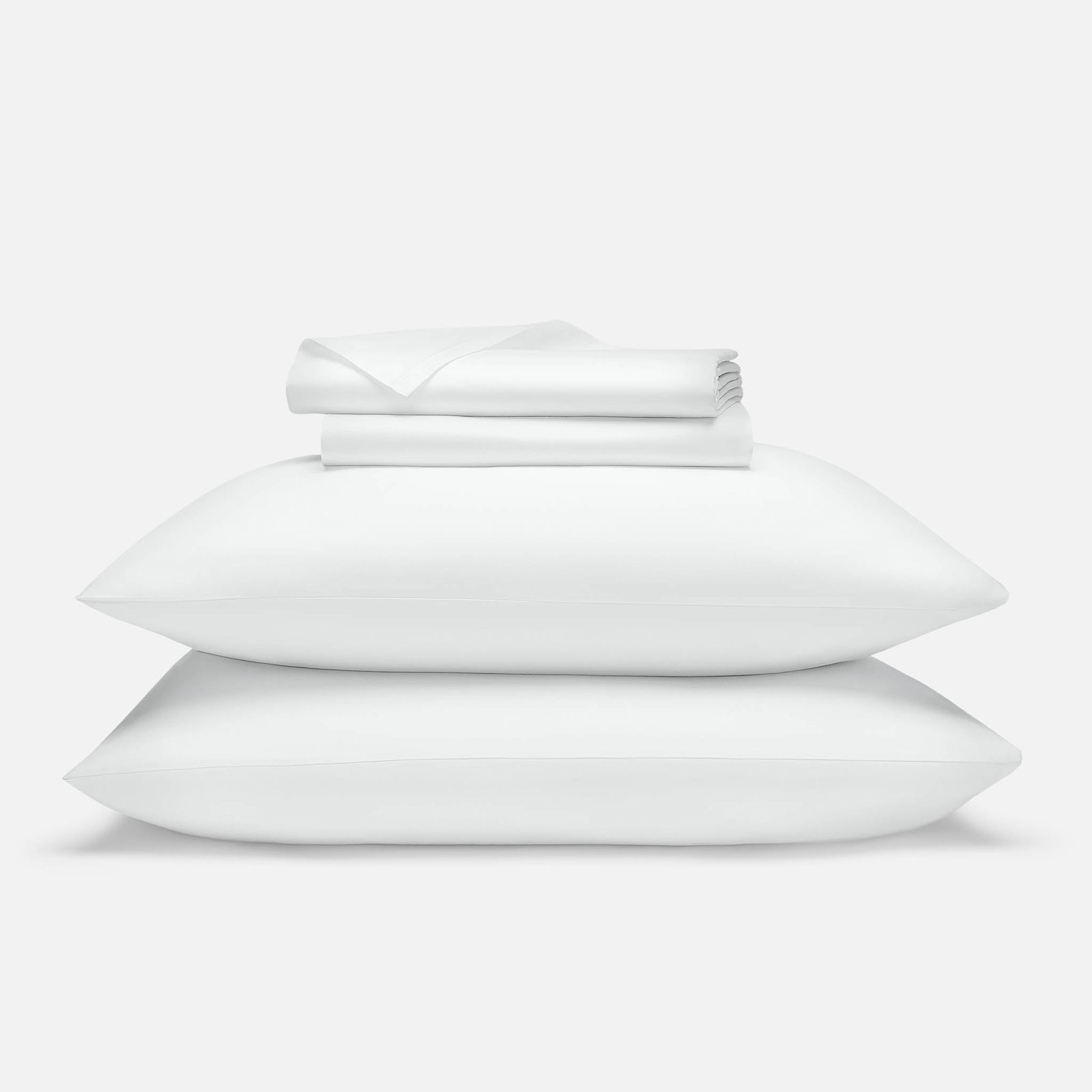 Brooklinen Luxe Sateen Core Sheet Set in white on a bed