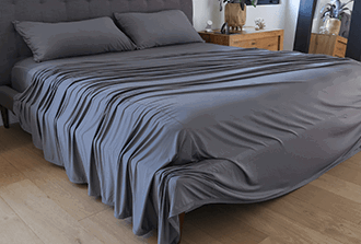 SHEEX performance sheets styled on a bed