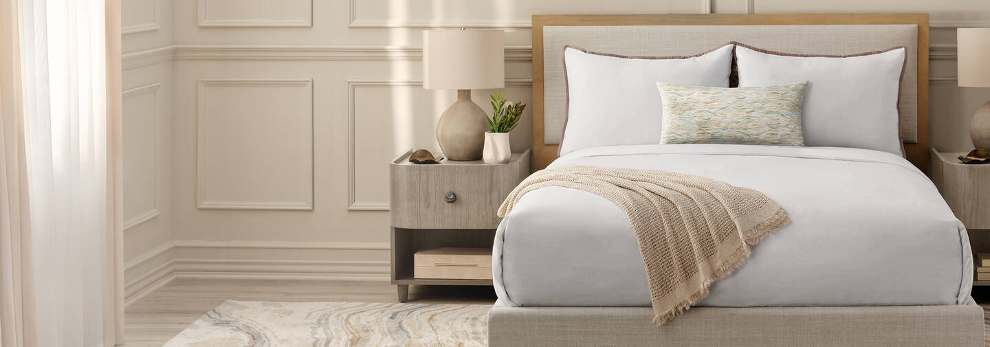 Layered white hotel bedding collection with duvet and pillows